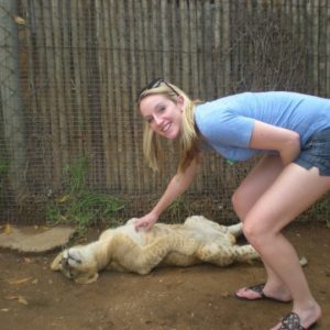 Abby Michaud with a lion pup in Johannesburg, South Africa